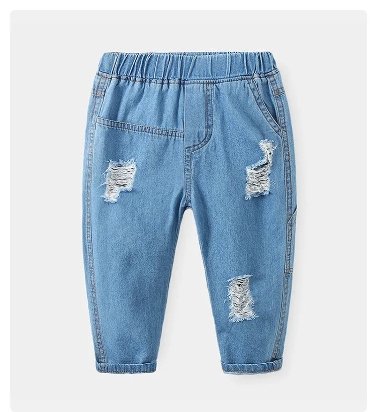 Vaqueros HoneyCherry de moda para niño. Estos pantalones tienen un acabado esmerilado y presentan agujeros rotos a la moda.