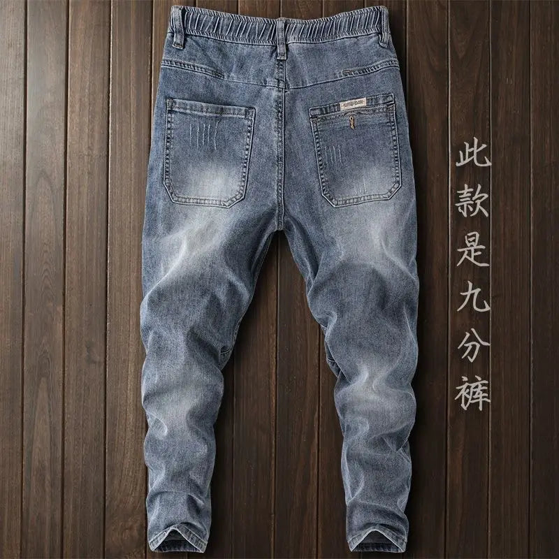 Pantalones vaqueros de mezclilla de lujo de estilo coreano para hombre con cintura elástica y cordón ajustable para otoño, vaqueros elásticos casuales para hombre