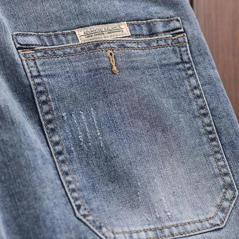 Pantalones vaqueros de mezclilla de lujo de estilo coreano para hombre con cintura elástica y cordón ajustable para otoño, vaqueros elásticos casuales para hombre