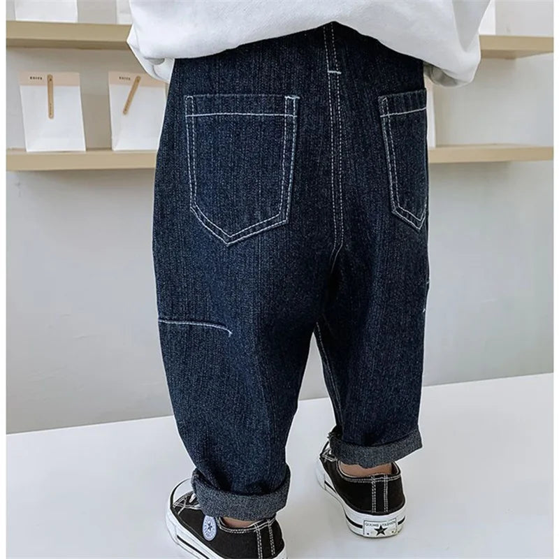 Pantalones vaqueros de color liso de estilo moderno para niños, nuevos, casuales y versátiles, vaqueros elásticos y sueltos para bebés.