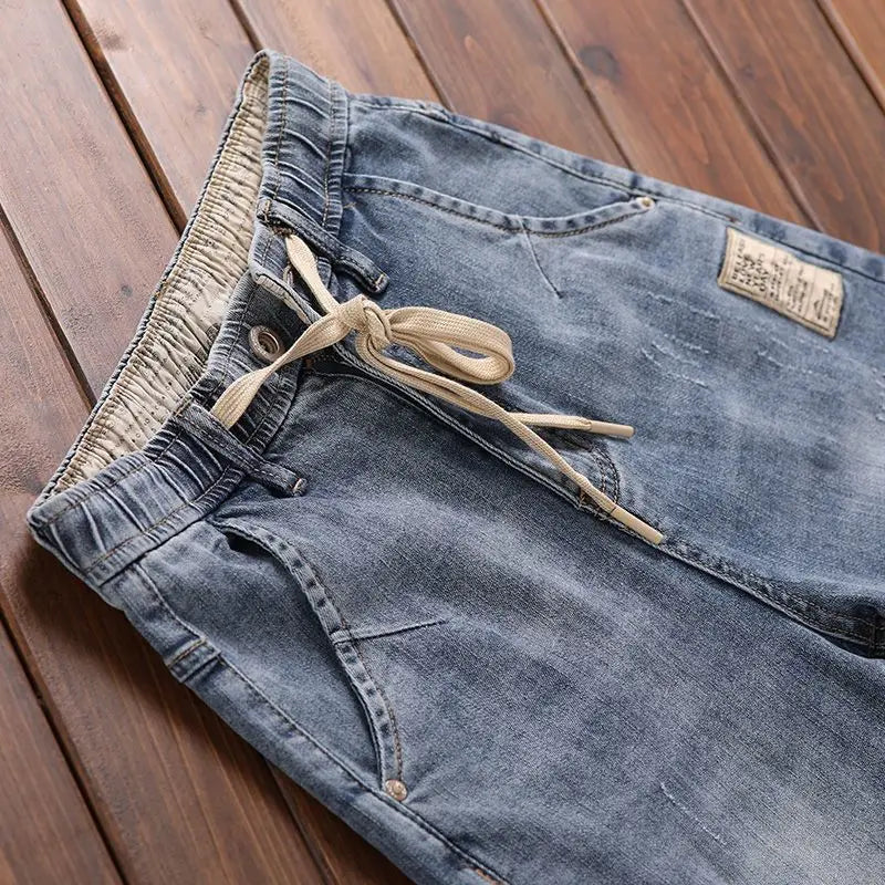 Pantalones vaqueros de mezclilla de lujo de estilo coreano para hombre con cintura elástica y cordón ajustable para otoño, vaqueros elásticos casuales para hombre