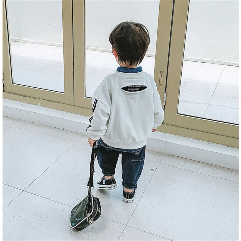 Pantalones vaqueros de color liso de estilo moderno para niños, nuevos, casuales y versátiles, vaqueros elásticos y sueltos para bebés.