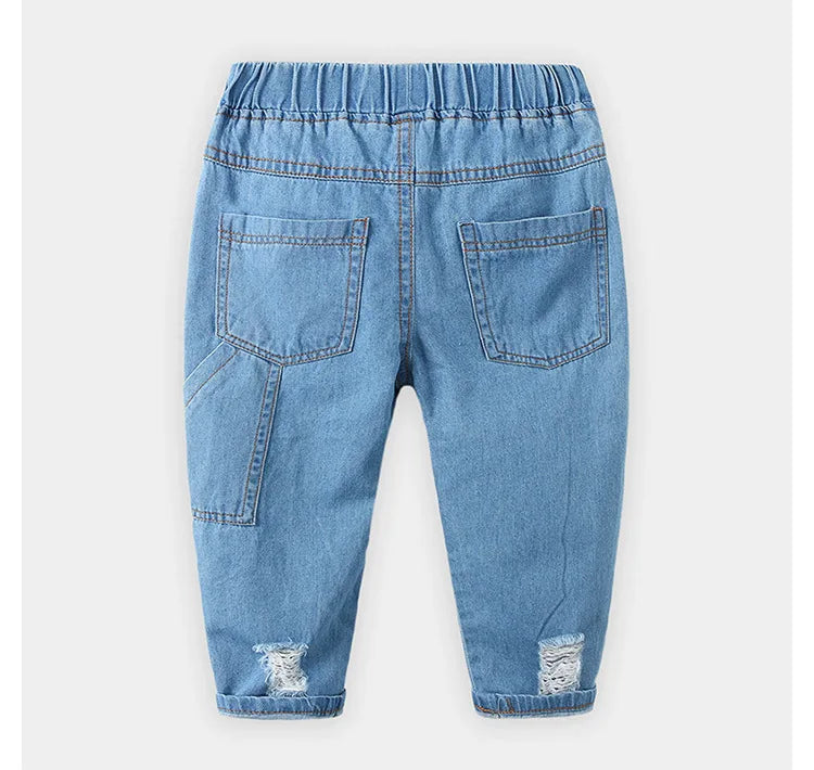 Vaqueros HoneyCherry de moda para niño. Estos pantalones tienen un acabado esmerilado y presentan agujeros rotos a la moda.